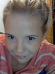 Older bitch is taking off her bra for a photoshoot