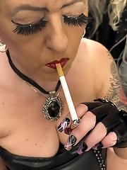A woman smoking a cigarette and sucking her lover s penis